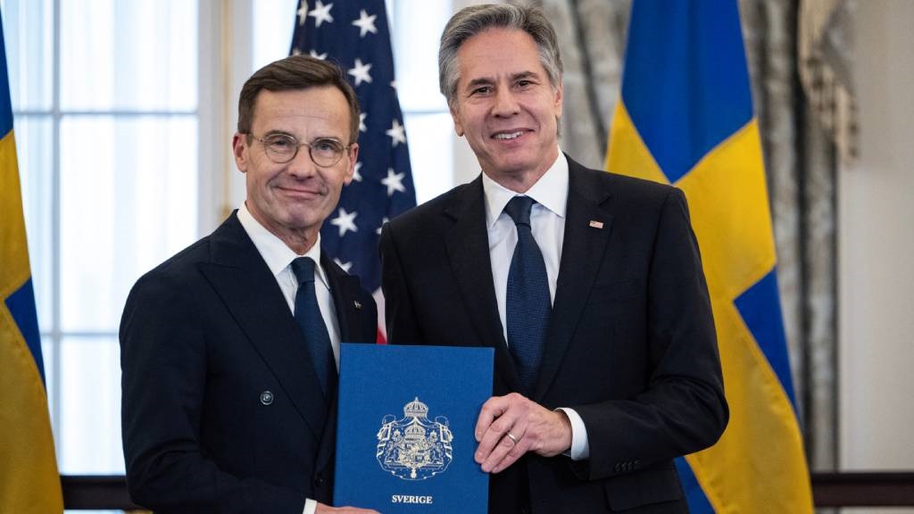 US Secretary of State Antony Blinken receives the NATO ratification documents from Swedish Prime Minister Ulf Kristersson during a ceremony at the US State Department, as Sweden formally joins the North Atlantic alliance, in Washington, DC. (Andrew Caballero-Reynolds/AFP)