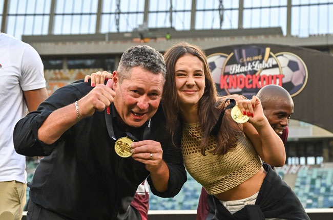 Steven Barker, head coach of Stellenbosch FC, with his daughter Nikita, during the Carling Knockout final trophy celebrations.