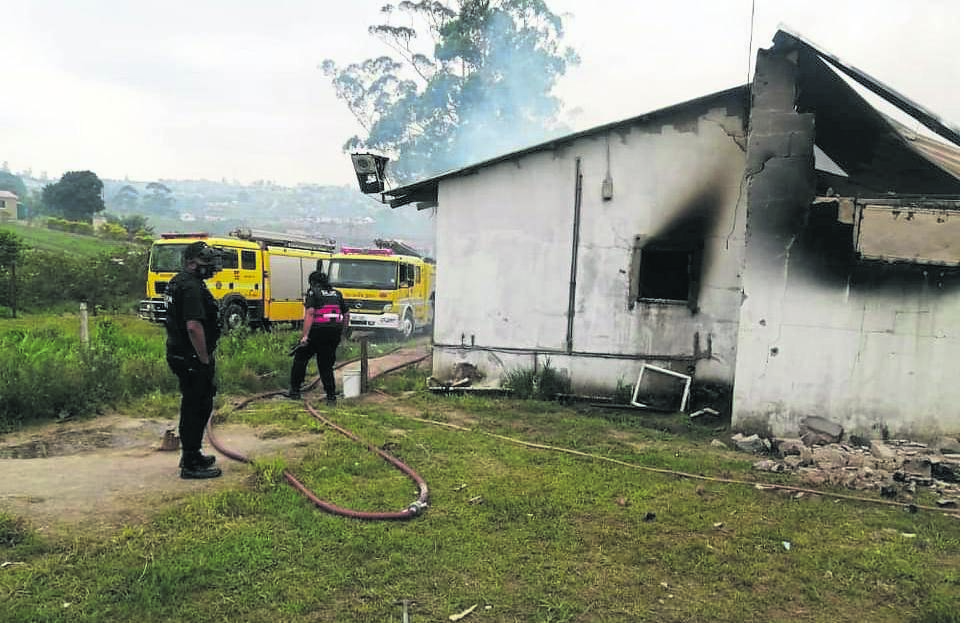 Reaction Unit officers at the house that caught fire at Mthebeni area on Sunday.