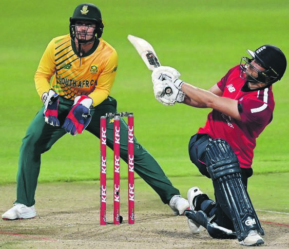 Dawid Malan of England smashes a six as wicketkeeper Quinton de Kock of South Africa looks on during the third T20 International between the two countries in Cape Town this month. Picture: Shaun Botterill / Getty Images