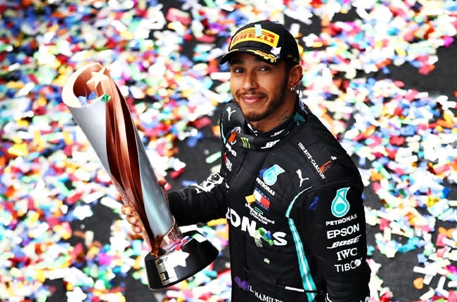 Lewis Hamilton celebrates with his seventh world title trophy at the 2020 Turkish Grand Prix.