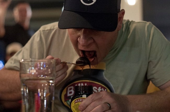 Billy Cowley tucks into a jar of Marmite on his way to a new Guinness World Record. He ate 420g of the sandwich spread in 60 seconds to break the 2018 record. (Photo: Supplied) 