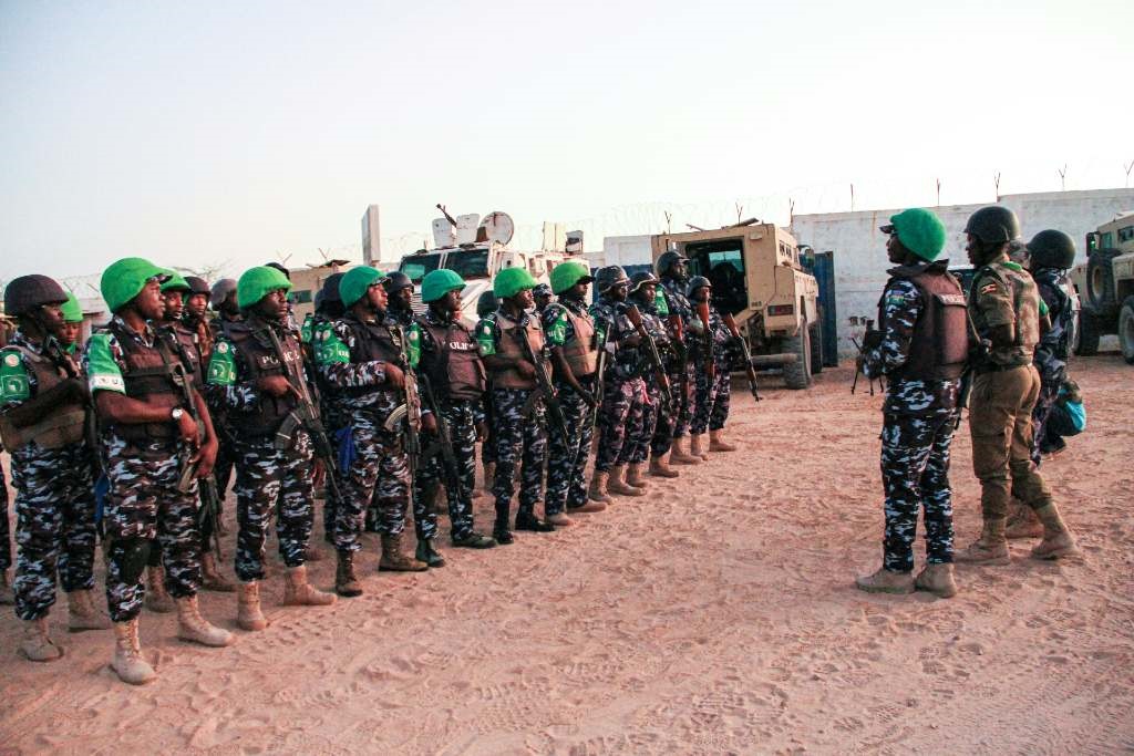 Police officers of the African Union's peacekeeping mission in Somalia (AMISOM) from Uganda, Kenya, Sierra Leone, Nigeria, Ghana and Zambia gather before their night patrol deployment at the base in Mogadishu on 17 September 2019.
