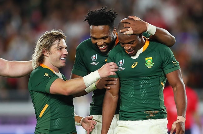 Springbok wing Makazole Mapimpi celebrates with Faf de Klerk and Lukhanyo Am after scoring his team's first try during the Rugby World Cup 2019 final between England and South Africa.