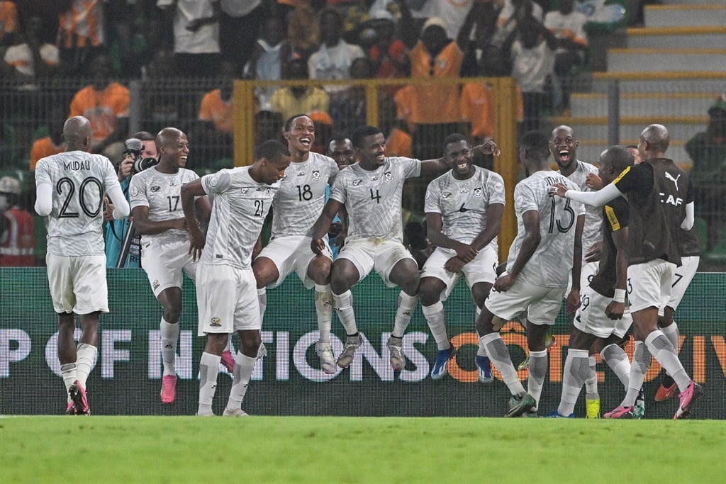 South Africa's players celebrate after scoring their team's first goal from the penalty spot during the Africa Cup of Nations (CAN) 2024 semi-final football match between Nigeria and South Africa at the Stade de la Paix in Bouake on 7 February 2024.
