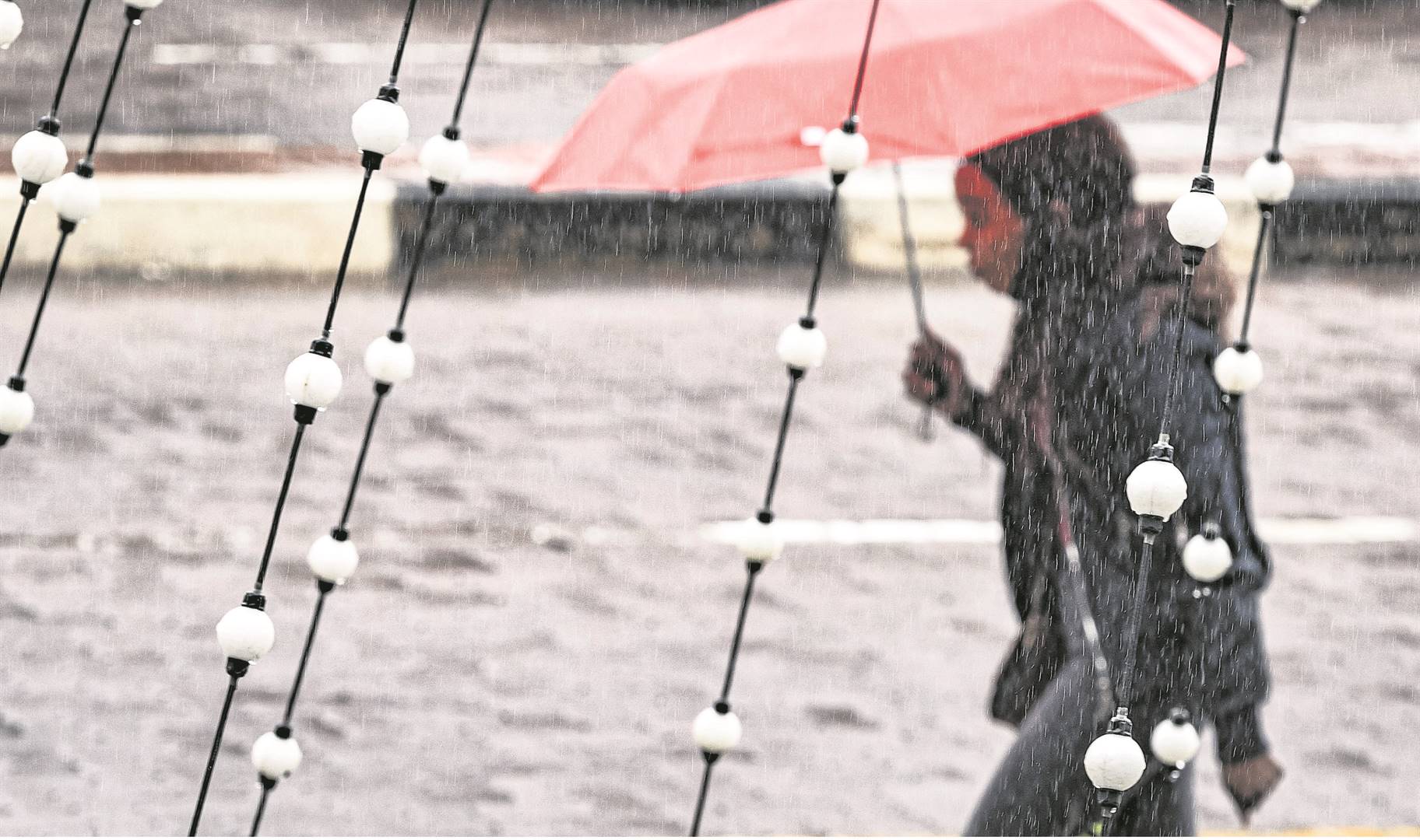  Woman with umbrella walks in the rain.