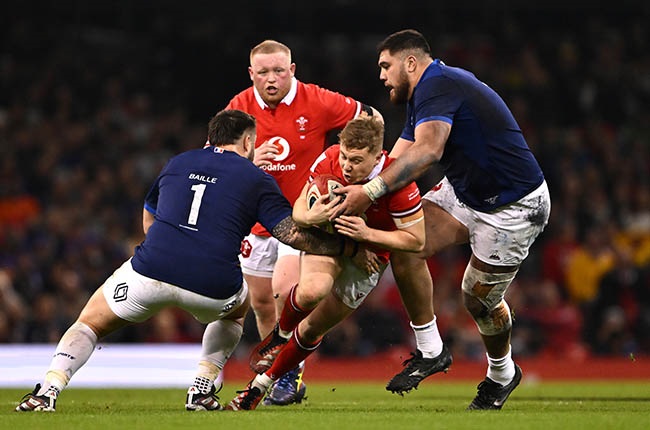 Sam Costelow of Wales is tackled by Cyril Baille and Emmanuel Meafou of France during Sunday's Six Nations clash (Dan Mullan/Getty Images)