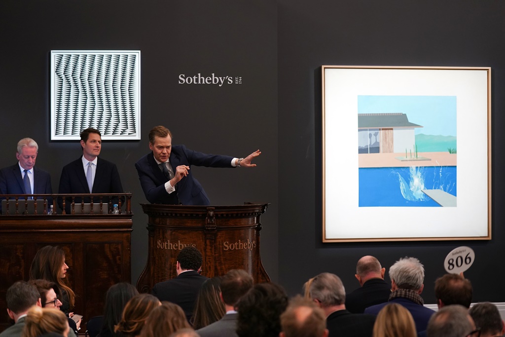 Auctioneer Oliver Barker brought the hammer down on David Hockney’s landmark pool painting ‘The Splash’, which achieved £23.1 million / $29.8 million – the third highest price for a work by David Hockney at auction and eight times that achieved when the painting last sold at auction in 2006 for £2.9 million / $5.4 million at Sotheby's on February 11, 2020 in London, England. (Photo by Michael Bowles/Getty Images for Sotheby's )