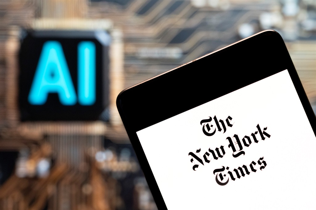 The American newspaper The New York Times (NYT) logo seen displayed on a smartphone with an Artificial intelligence (AI) chip and symbol in the background. (Photo Illustration by Budrul Chukrut/SOPA Images/LightRocket via Getty Images)