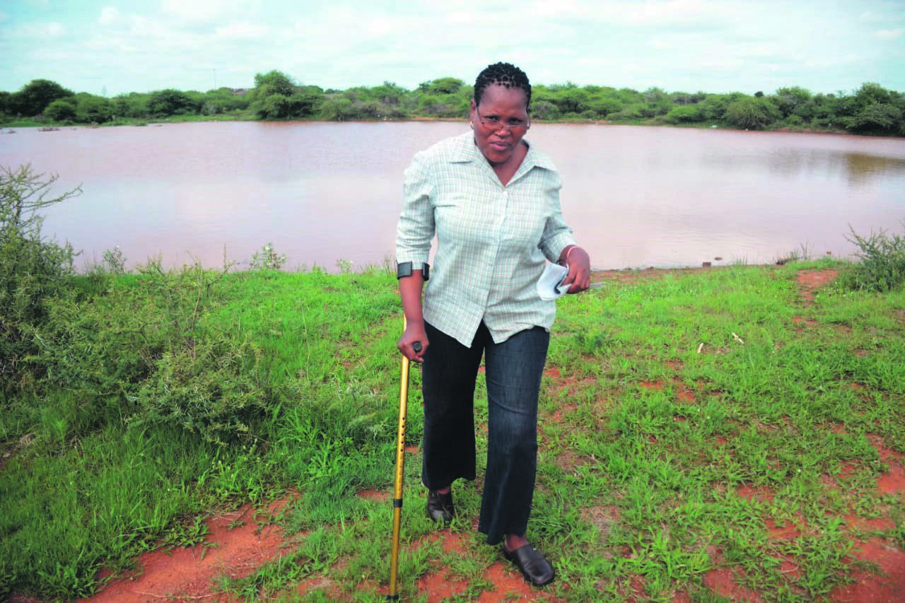 Tebogo Kgomo is complaining about a dam next to her home in Makapanstad, North West.                 Photo by Raymond Morare