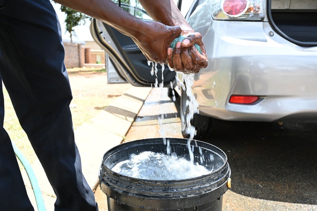 Street hustlers at Busy Corner Car Wash in Zola: P