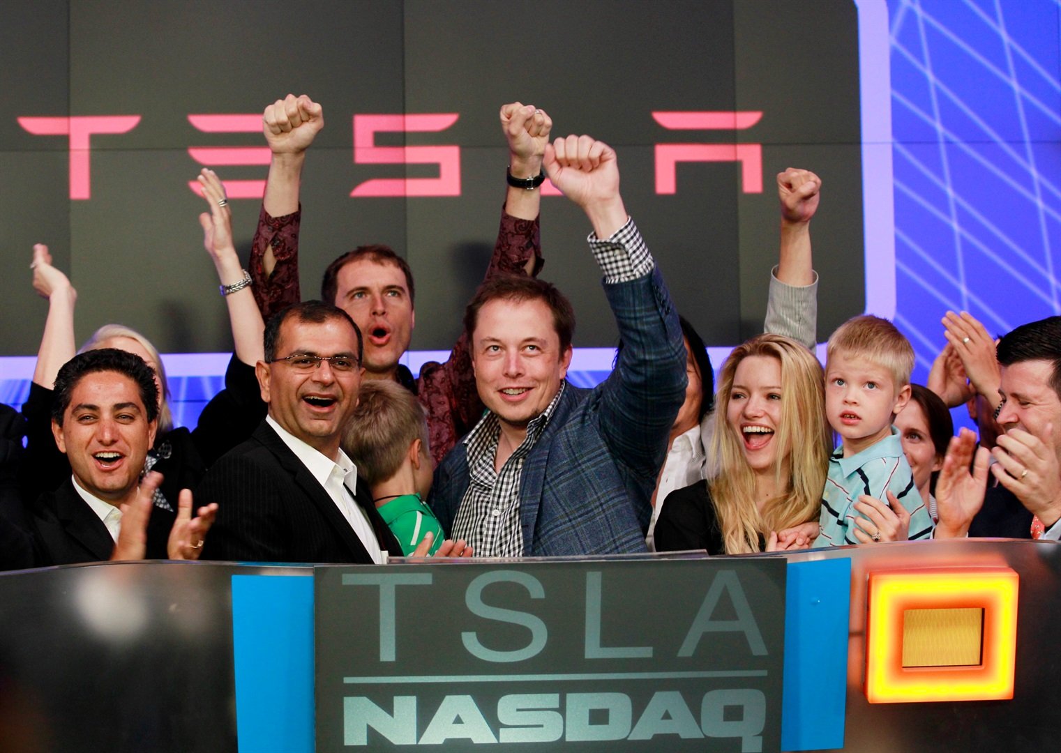 CEO of Tesla Motors Elon Musk waves after ringing the opening bell at the NASDAQ market in celebration of his company's initial public offering in New York June 29, 2010.
