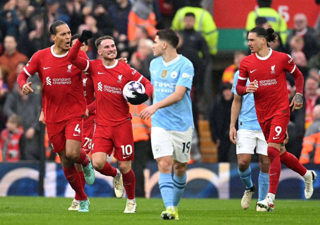 LIVERPOOL, ENGLAND - MARCH 10: Alexis Mac Allister of Liverpool celebrates scoring his teams first goal from a penalty kick alongside teammate Virgil van Dijk during the Premier League match between Liverpool FC and Manchester City at Anfield on March 10, 2024 in Liverpool, England. (Photo by Michael Regan/Getty Images)