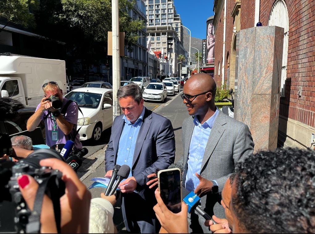 DA leader John Steenhuisen and the party's national spokesman Solly Malatsi outside the Cape Town Police Station on Monday. 