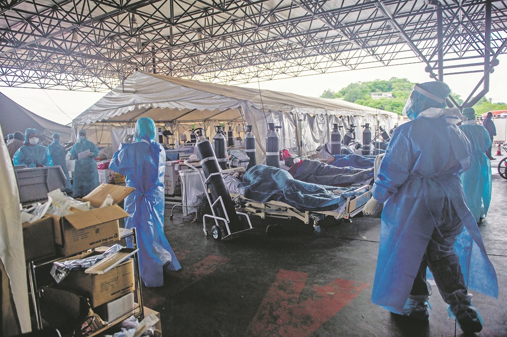 Health care workers and patients in the temporary outside area at Steve Biko Academic hospital. Photo by Gallo Images/Alet Pretorius)