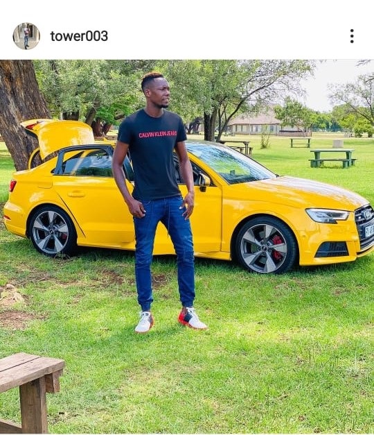 Kaizer Chiefs defender, Erick Mathoho, posing next to a car of his choice. 