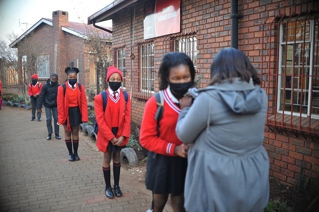 Pupils line up to get a temperature check at Monde Primary School in Ekurhuleni.