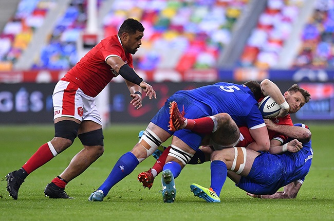Dan Biggar of Wales is tackled by Paul Willemse and Charles Ollivon of France.  (Photo by Aurelien Meunier/Getty Images)