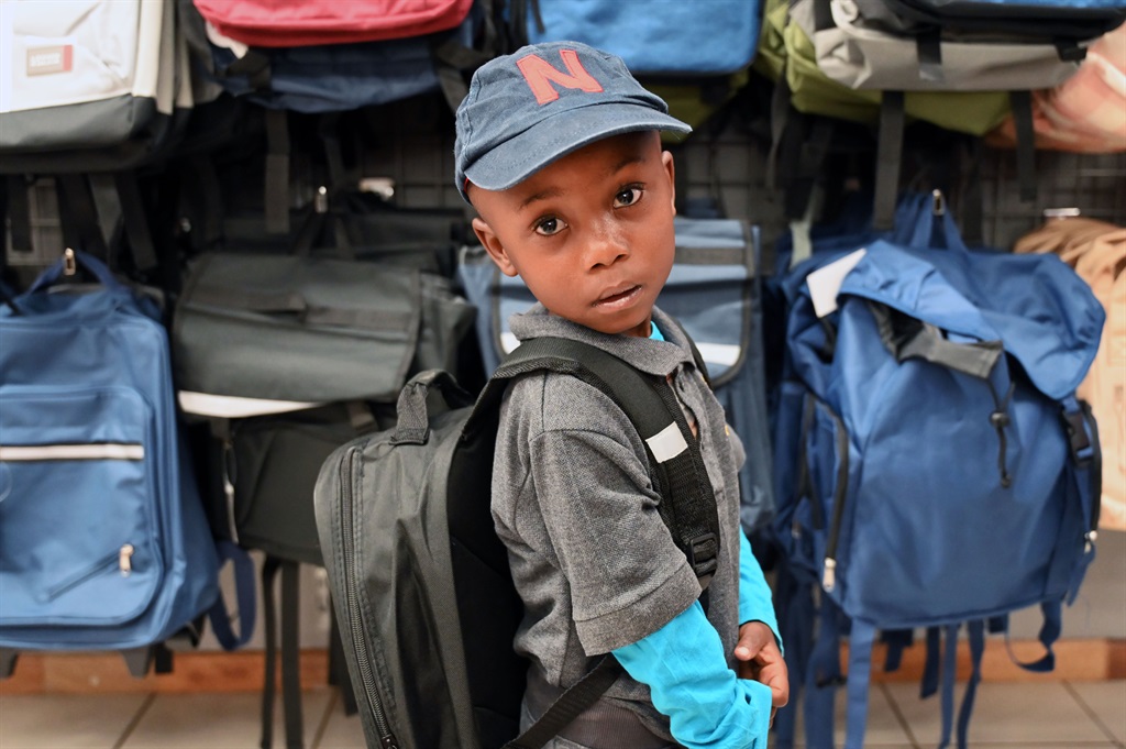 Njabulo Rooibaietjie trying on a school backpack d