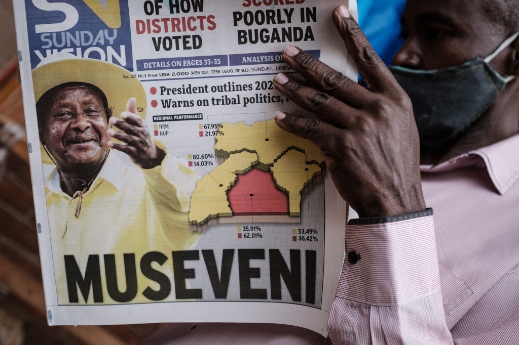 A man reads the "Sunday Vision" newspaper whose front page shows a portrait of re-elected President Yoweri Museveni. (Yasuyoshi Chiba, AFP)