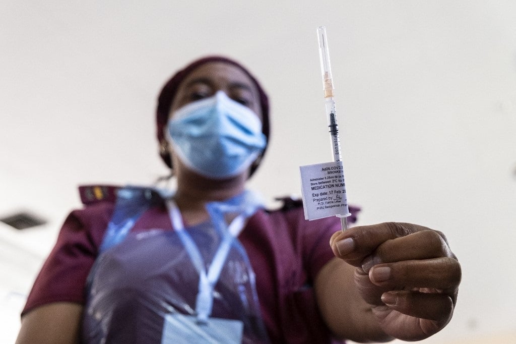 A health worker holds the Johnson and Johnson vaccine at the Chris Hani Baragwanath Hospital in Soweto.