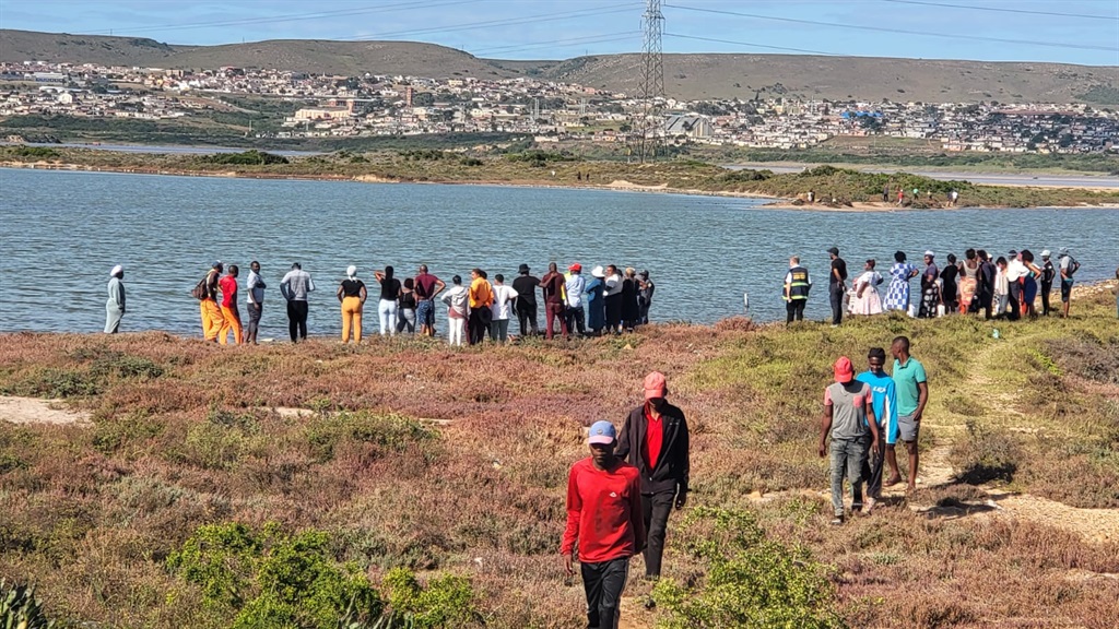 The community of Missionvale gathered at the scene where the bodies were found.