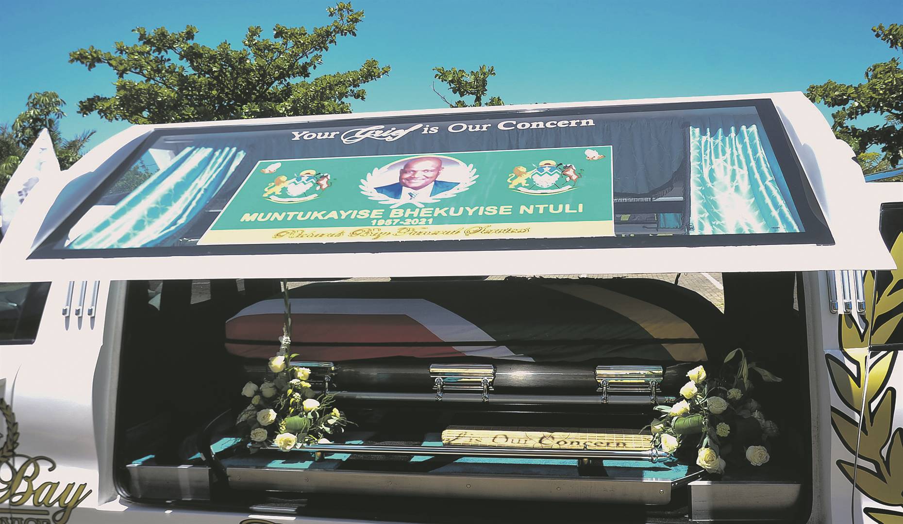 KZN Transport MEC Bheki Ntuli’s coffin (right) in the hearse during his funeral service held at Esikhaleni community hall