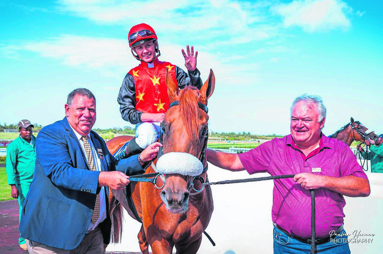 Jockey Richard Fourie indicates he rode four winners as he and United Express are joined by trainer Alan Greeff and owner Andrea Puggia. 