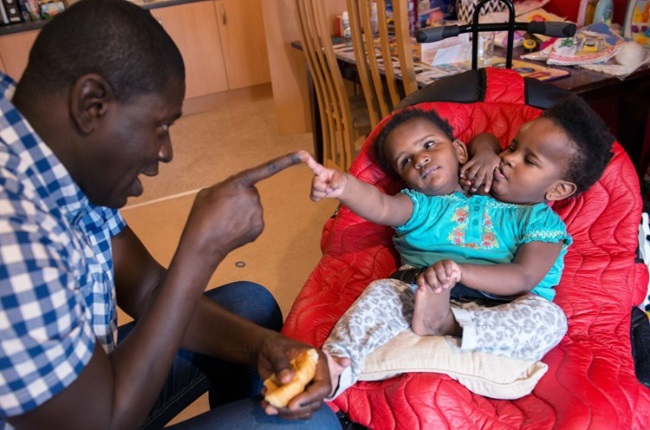 Conjoined twins Ndeye and Marieme Ndiaye are thriving after their father, Ibrahima, moved heaven and earth to get them specialised medical treatment. (PHOTO: JUSTGIVING)