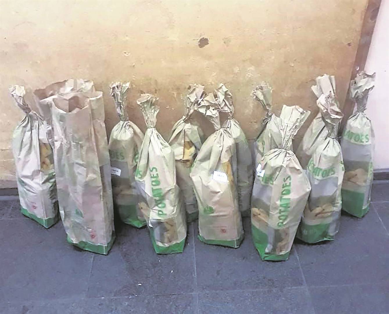 Cops bust a store owner who sold booze hidden in potato bags. 