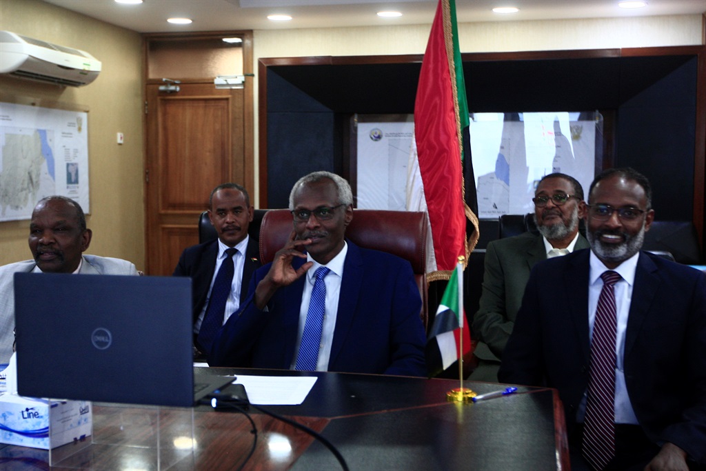 Sudan's Minister of Irrigation and Water Resources Yasser Abbas (C) participates in a videoconference with his Egyptian and Ethiopian counterparts (unseen) in the Sudanese capital Khartoum 