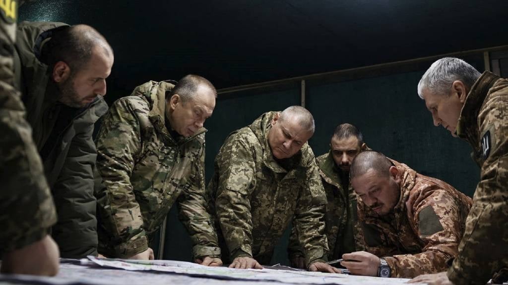 This handout photograph released on 14 February 2024 by the Press service of Ukrainian Armed Forces, shows Commander-in-Chief of the Armed Forces of Ukraine Oleksandr Syrsky (2nd L) and Ukraine's Defence Minister Rustem Umerov (L) visiting the frontline positions at an undisclosed location in eastern Ukraine. 