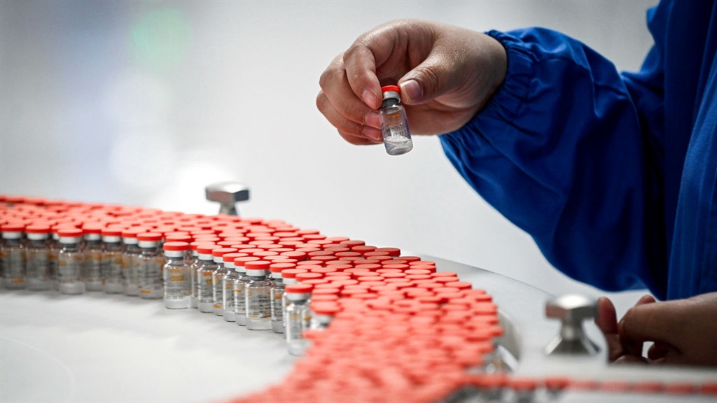 A staff member works during a media tour of a new factory built to produce a COVID-19 coronavirus vaccine at Sinovac, one of 11 Chinese companies approved to carry out clinical trials of potential coronavirus vaccines, in Beijing on September 24, 2020. (Photo by WANG ZHAO / AFP) (Photo by WANG ZHAO/AFP via Getty Images)