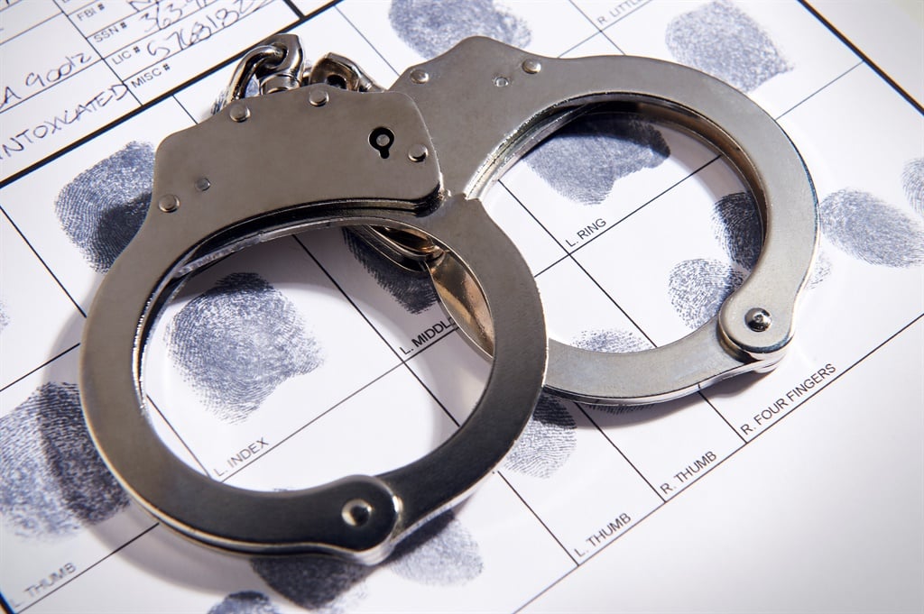 Handcuffs laying on top of fingerprint chart.