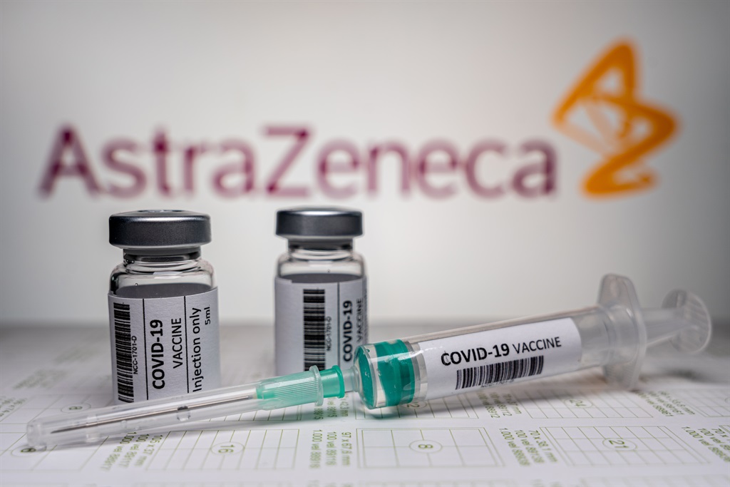 Vials and syringe in front of an AstraZeneca logo. 