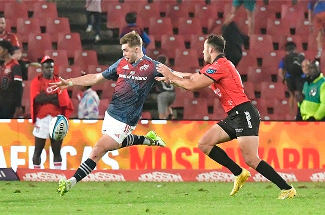 Munster pivot Jack Crowley, evading a tackle here by the Lions' Erich Cronje, dictated play well for the Irish at Ellis Park. (Sydney Seshibedi/Gallo Images)