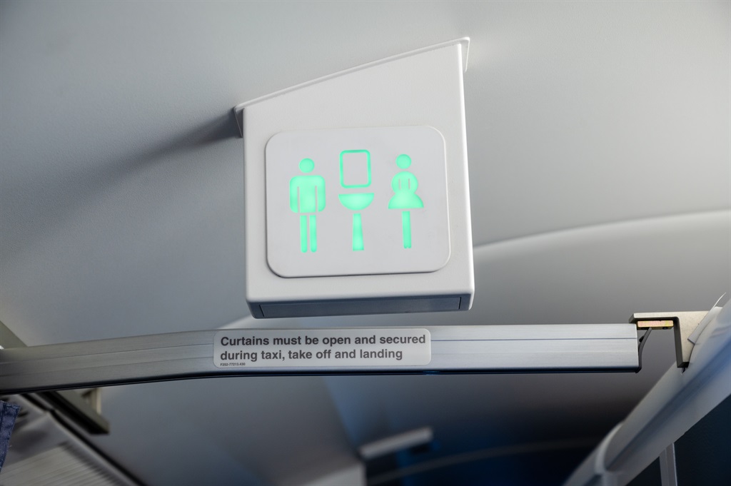Lavatory / toilet sign on a commercial aircraft. S