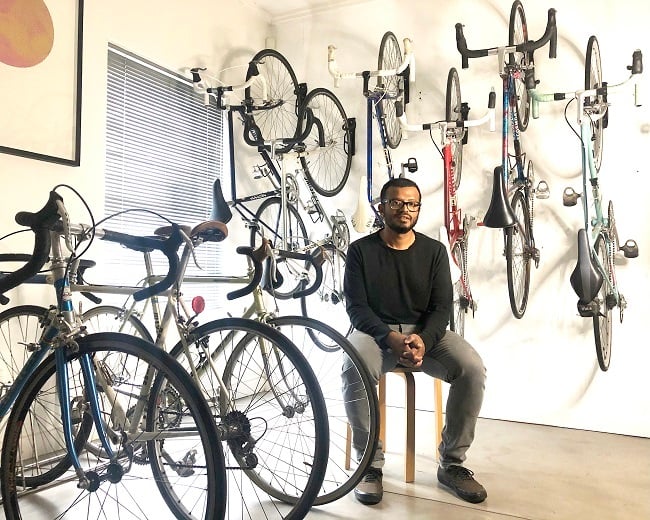 Las sitting amongst some of his impressive bicycle collection (Photo: Las Madurasinghe)