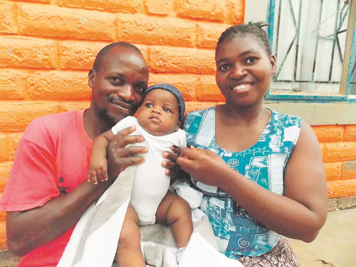 Sam Mawire and his wife Sinikiwe Maombedze, who’re deaf and can’t talk, holding their daughter Stella Mawire. ­          Photo by Raymond Morare