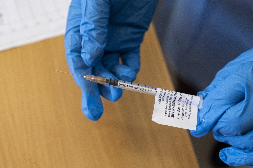 A health worker holds the Johnson and Johnson vaccine. 