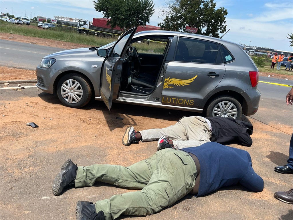 Two suspected CIT robbers lying next to their security branded vehicle. Photo by Nhlanhla Khomola