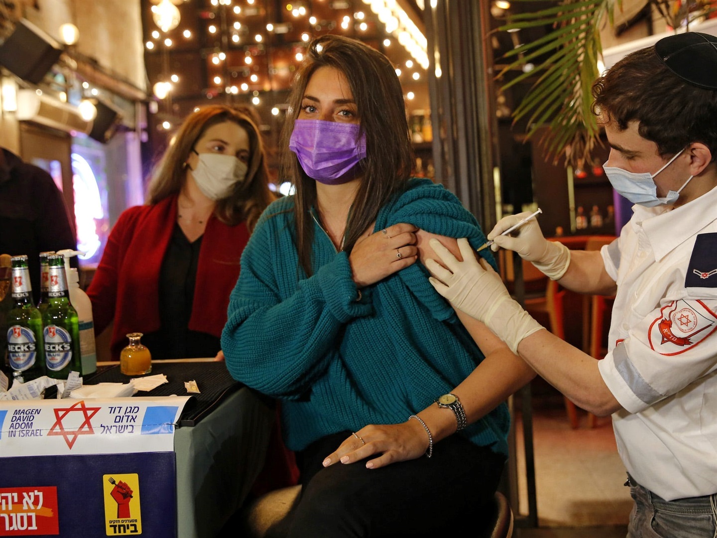 A woman gets a Covid-19 vaccine at a bar in Tel Aviv, Israel, on February 18, 2021. 