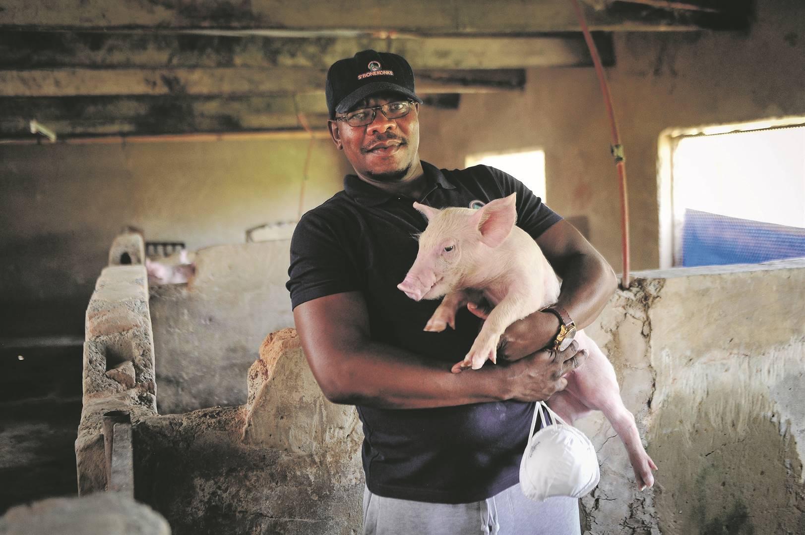 Reggie Mkhize with one of the weaners at his farm in Brakpan