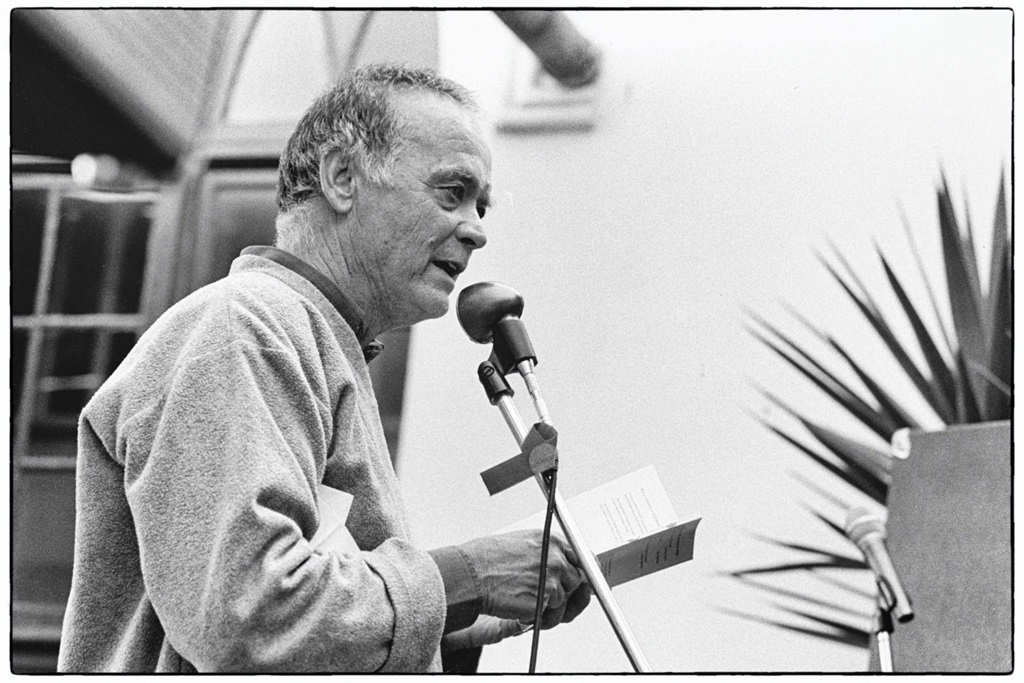 Poet, cartoonist and publisher Gus Ferguson delivers a reading during a book launch. (Photograph by Louis Reynolds)