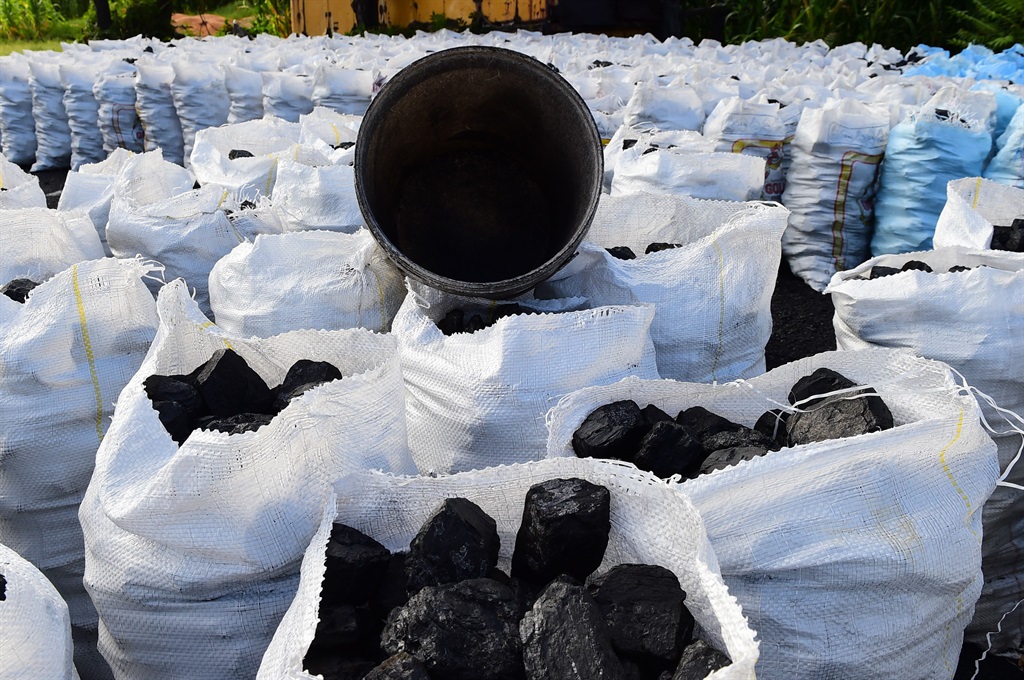 Bags of coal are ready to be sold at a coal yard i