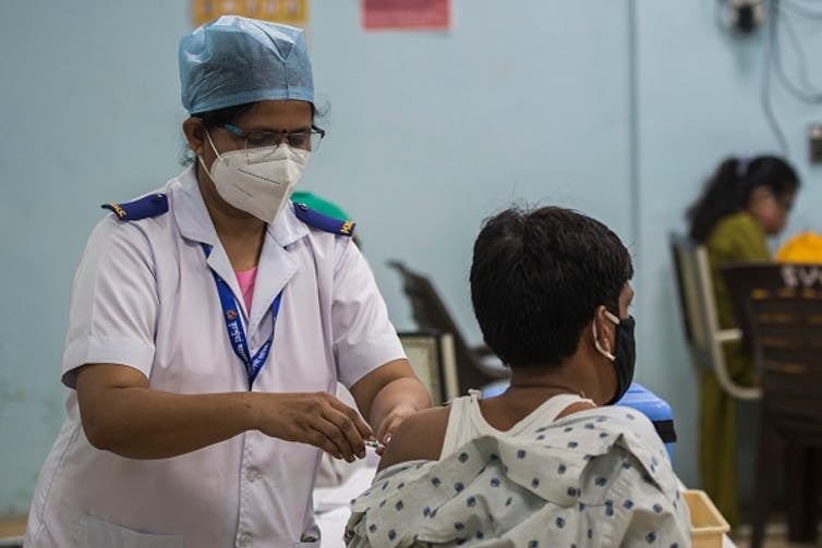 A medic administers a Covid-19 vaccine in Mumbai. Pratik Chorge/Hindustan Times via Getty Images