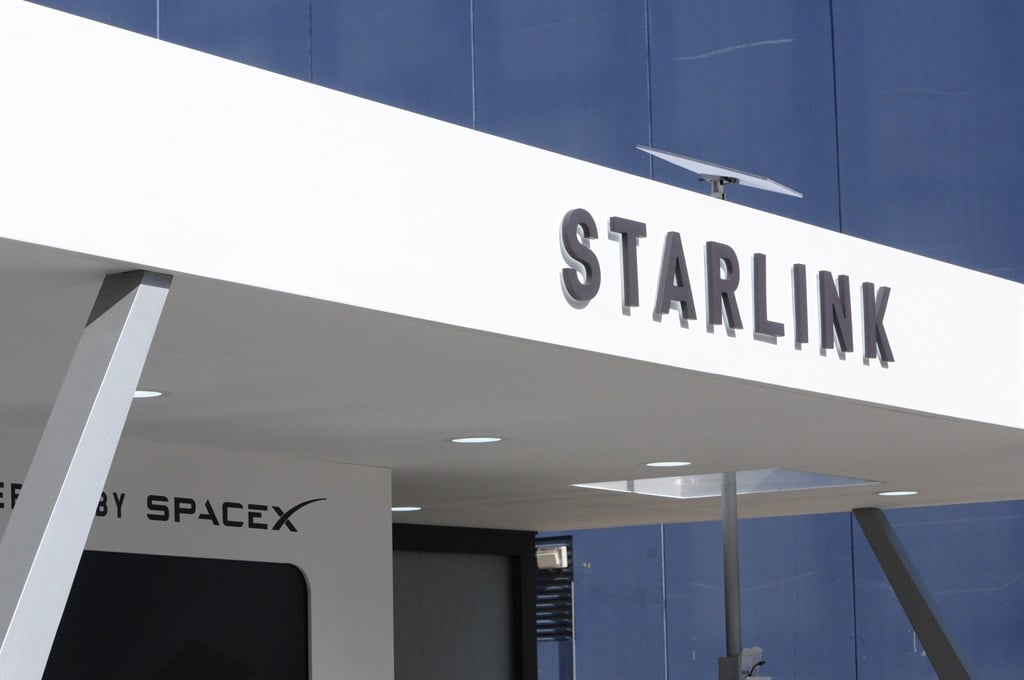 The logo of the Starlink satellite network, which is operated by the aerospace company SpaceX, can be seen at the marketing pavilion at the Mobile World Congress (MWC) trade fair in Barcelona in February 2024. A Starlink receiver can be seen on the roof above the logo. (Wolf von Dewitz/picture alliance via Getty Images)