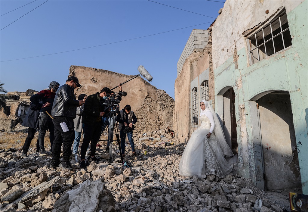 Makeup artists of a film school, prepare an actress dressed as a bride, before shooting a scene in the war-ravaged northern Iraqi city of Mosul. In a collaboration between the Mosul fine arts academy, a Belgian theatre company and UN cultural agency UNESCO, 19 students are getting a chance to make their first short films, in a city that still bears the scars of the brutal reign of the Islamic State group IS, who overran Mosul in 2014 and imposed their ultraconservative interpretation of Islamic law. (Zaid AL-OBEIDI / AFP)