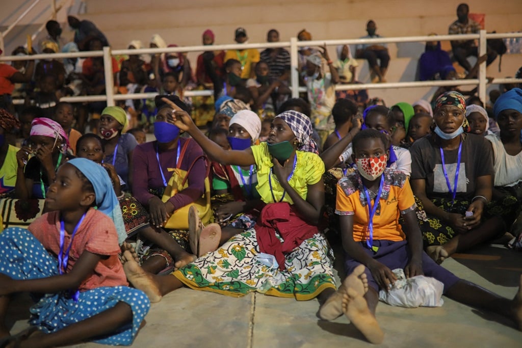 Internally displaced people from Palma gather in the Pemba Sports centre to receive humanitarian aid.