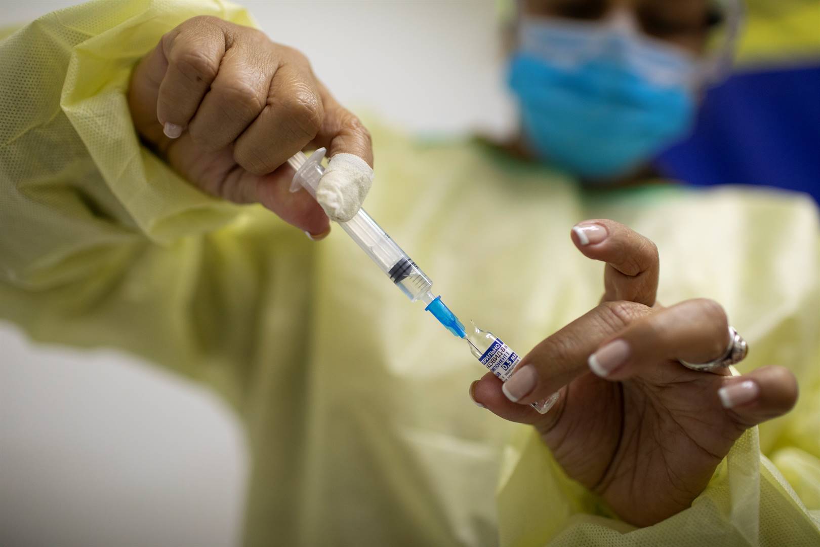 A medical worker fills a syringe with a vaccine against Covid-19.